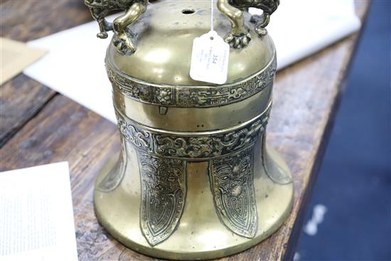 A Chinese Ming bronze bell, 16th/17th century, Height including later wooden dragon stand 73cm